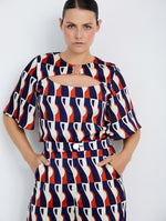 Blusa Satinada con Estampado Gráfico y Detalle Metálico