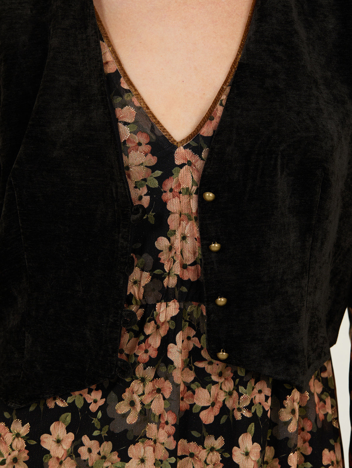 Detalle del chaleco efecto chenilla sobre vestido floral